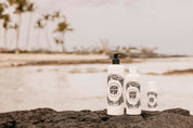 Skincare bottles with 'Satin Off' branding on a beach.