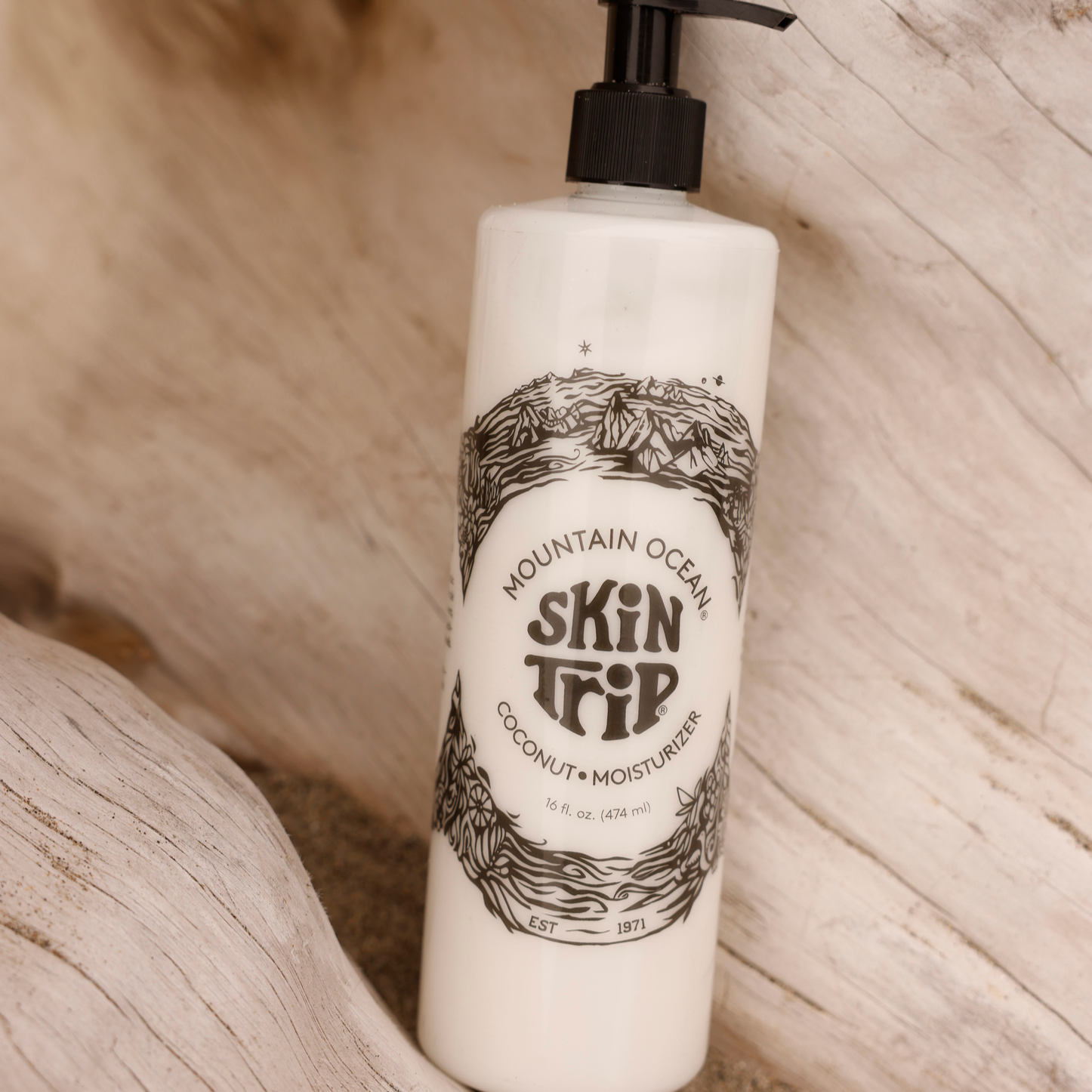 Lotion bottle labeled 'Skin Trip' by Mountain Ocean on a wooden surface
